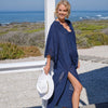 Woman in navy blue maxi cover up with broderie detail and necline and sleeve edges