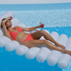 Woman wearing coral halterneck bikini lying on lilo